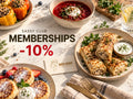 A styled food spread on a light marble table with plates of stuffed peppers, a bowl of red soup with sour cream, pancakes with fruit and whipped cream, and chicken wrap rolls with a side of white sauce. Large overlaid text reads 'Sassy Club Memberships -10%' and a small card says 'Miss Sassy Gourmet Meals.